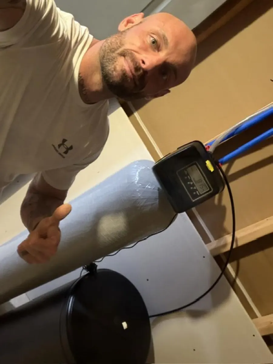 Technician installing a water softener tank