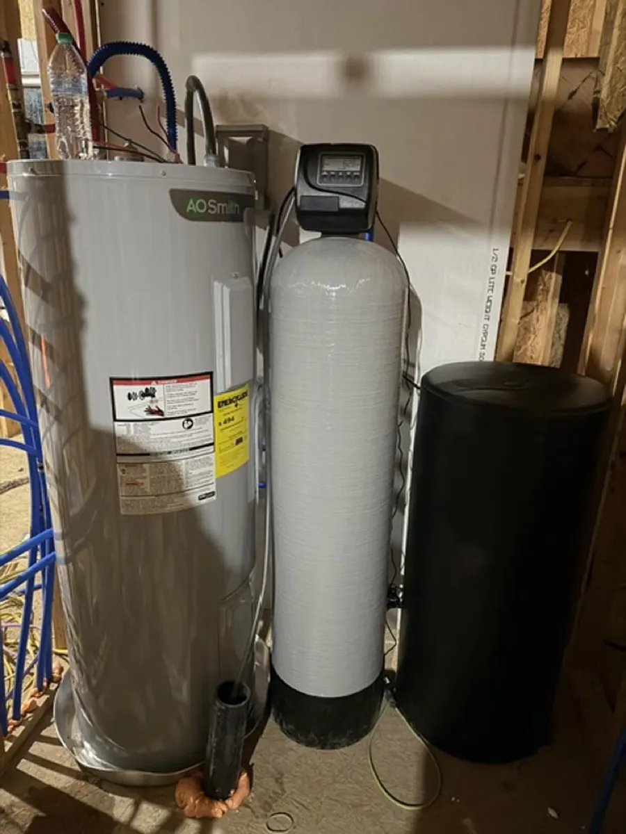 Water softener and brine tank installed next to a water heater