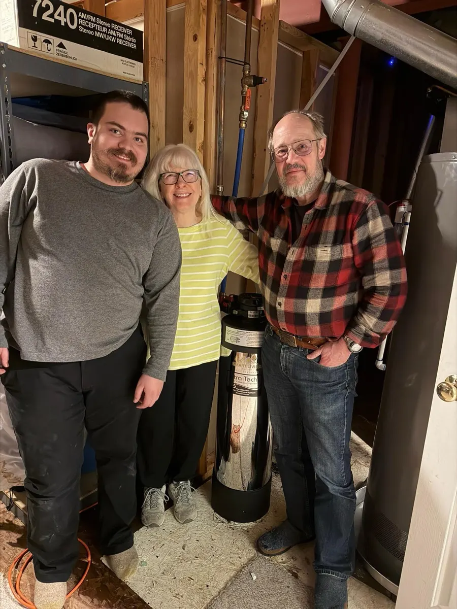 Homeowners and a technician with a newly installed water system